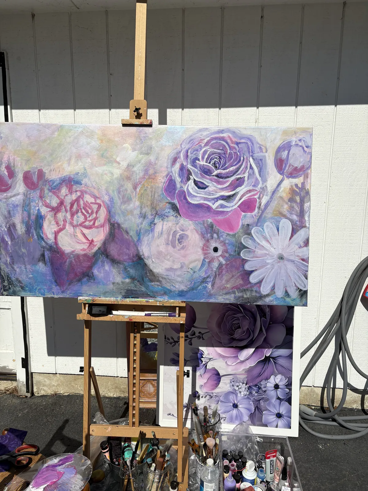 Commission painting on an outdoor easel as purple and pink roses begin to take shape