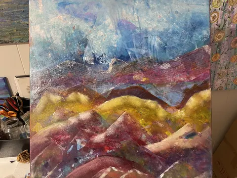 Sold original by Agata May'kowska — Abstract colorful landscape painting with mountains, sky, and hills in shades of blue, purple, yellow, red, and white.