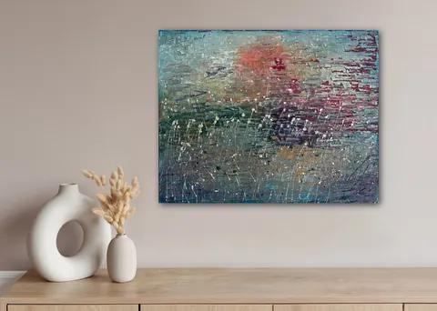 Sold original by Agata May'kowska — Abstract modern painting with textured brushstrokes in shades of blue, pink, and green hanging on a neutral wall above a wooden surface. On the surface, there is a white…