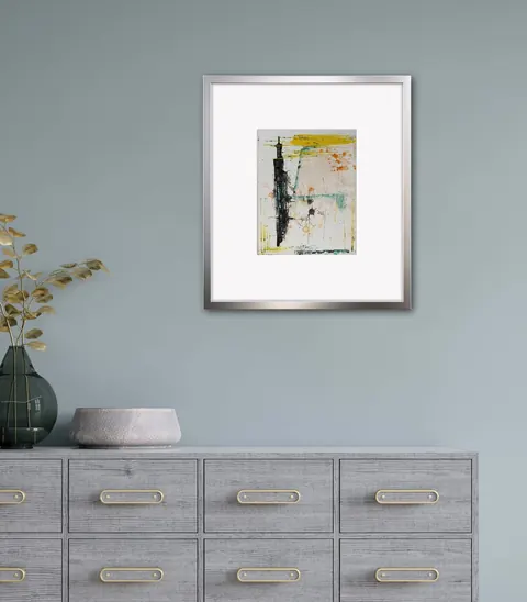 Sold original by Agata May'kowska — Abstract painting with black, orange, yellow, teal, and gray colors hanging on a light green wall above a gray dresser decorated with a green vase with dried gold leaves…