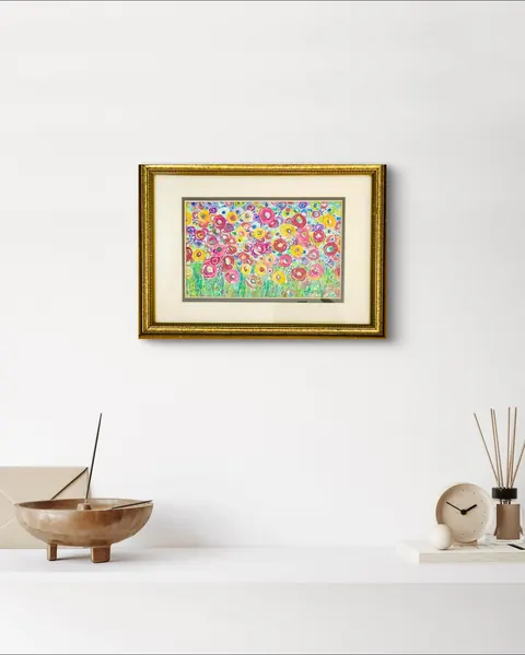 Sold original by Agata May'kowska — A framed colorful floral painting hanging on a white wall above a white shelf with decorative objects including a bronze bowl, a clock, and a reed diffuser.