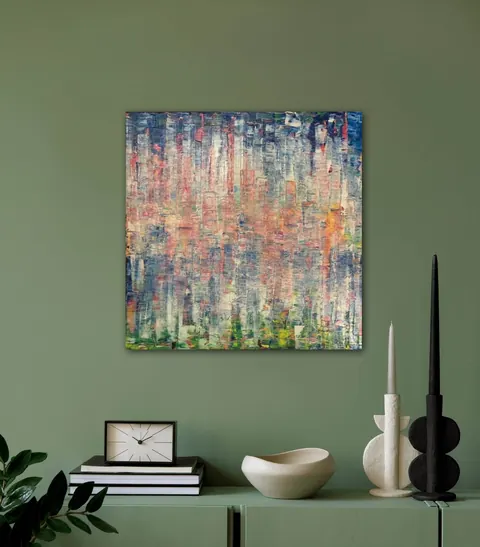 Sold original by Agata May'kowska — Green wall with an abstract colorful painting, a white clock on a stack of black and white books, a cream bowl, and modern black and white candles on a green cabinet.