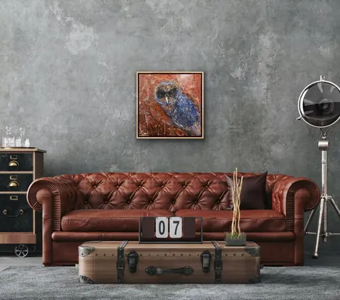 Sold original by Agata May'kowska — A living room with a tufted leather couch, a vintage trunk coffee table, and framed owl painting on a textured gray wall.
