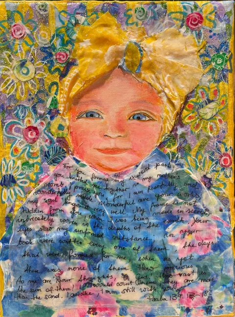 Sold original by Agata May'kowska — A mixed media artwork featuring a smiling child's face with blue eyes and rosy cheeks, surrounded by colorful floral patterns, glitter accents, and a handwritten…