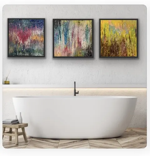 Sold original by Agata May'kowska — Modern bathroom with white bathtub, three abstract colorful paintings on the wall, small wooden stool with a bottle and towels, light wood floor, and a gray textured…