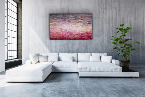 Sold original by Agata May'kowska — Modern living room with a white sectional sofa, a large window with black framing, colorful abstract painting on gray concrete wall, and a tall green potted plant.