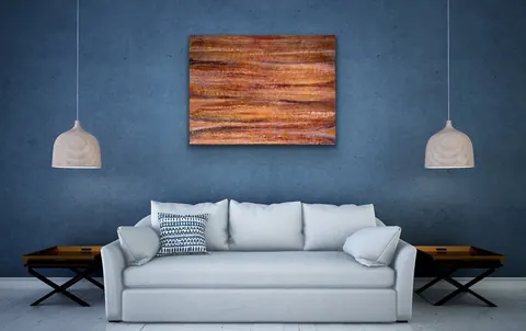 Sold original by Agata May'kowska — Modern living room with a white sofa, blue textured wall, orange abstract painting, two hanging pendant lights, and side tables.