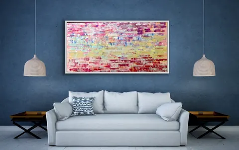 Sold original by Agata May'kowska — Modern living room with white sofa, blue textured wall, abstract pink and yellow painting, two hanging pendant lights, and wooden side tables.