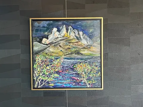 Sold original by Agata May'kowska — Painting of mountains with colorful foreground trees on a dark textured wall.