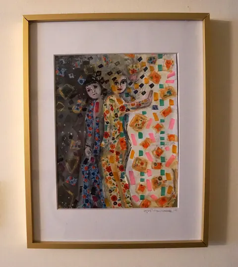 Sold original by Agata May'kowska — Painting of two women in colorful, patterned clothing standing close together surrounded by floating images of books and geometric shapes, with a darker background on…